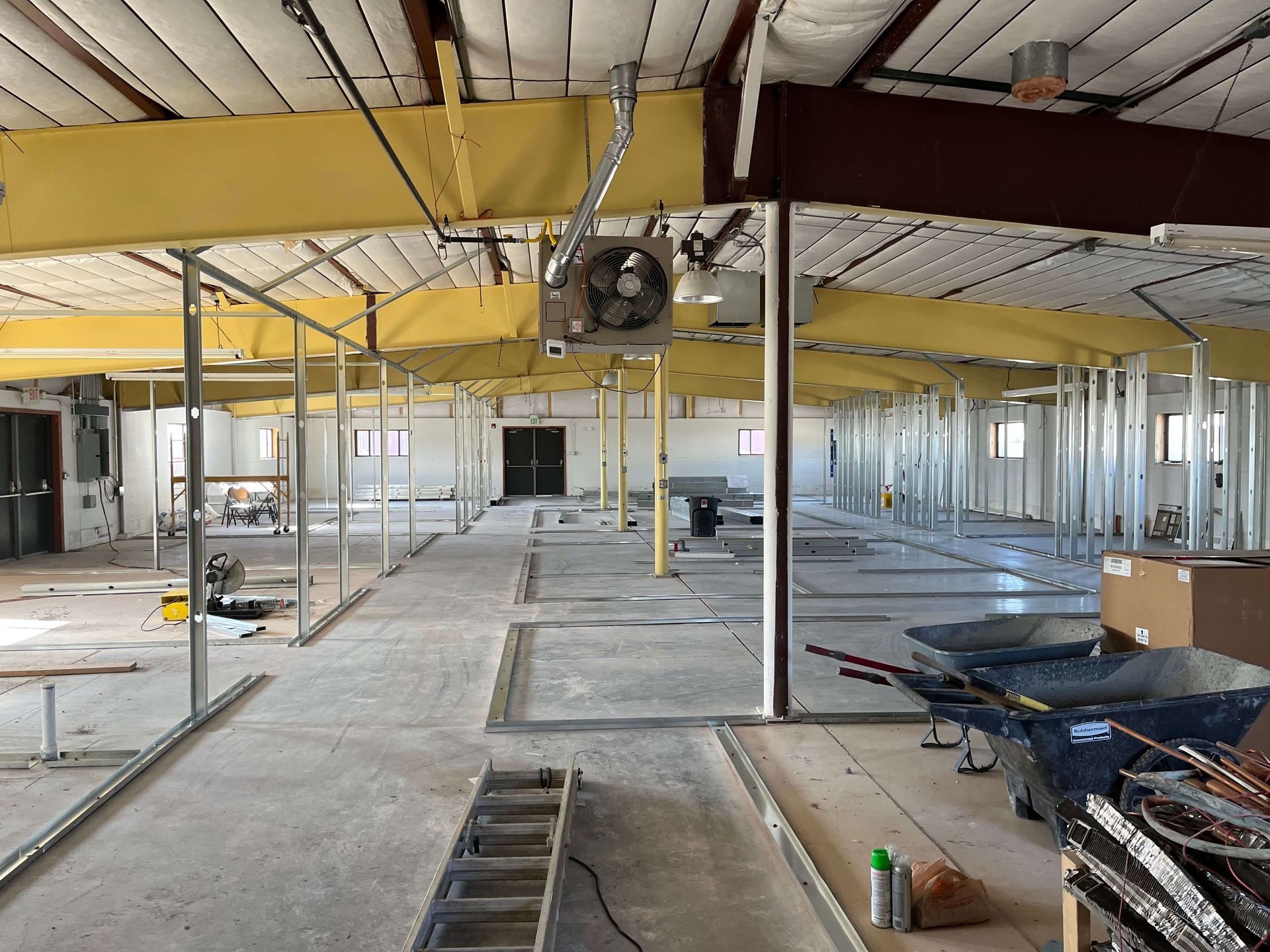 A large empty building under construction with a fan on the ceiling. Maven Construction, Montrose, CO