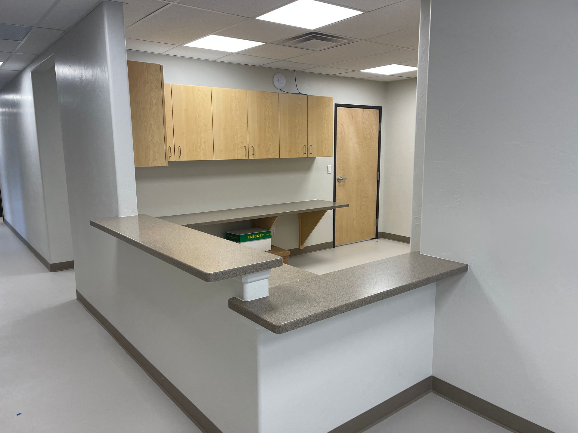 An empty office with a counter and cabinets Maven Construction, Montrose, CO
