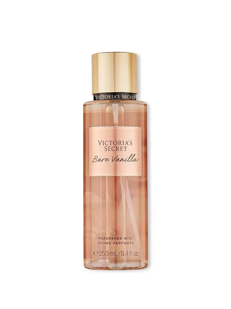 Frasco de bruma corporal color oro rosa con tapón dorado y anillo negro sobre fondo blanco.