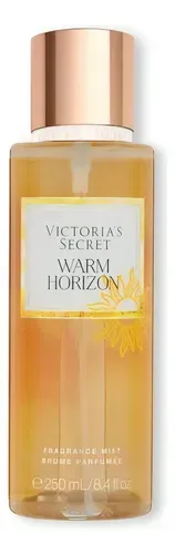 Frasco de bruma corporal Warm Horizon de Victoria's Secret con tapa dorada y líquido amarillo anaranjado.