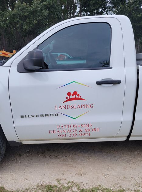 A white truck with landscaping written on the side of it