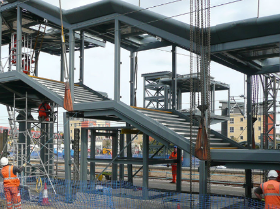 A group of construction workers are working on a bridge