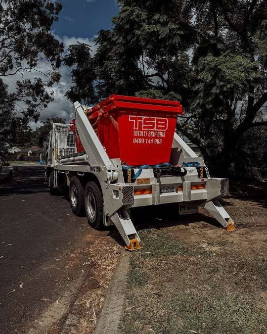 A Dumpster is Sitting on the Back of a Truck — Totally Skip Bins in Palen Creek, QLD