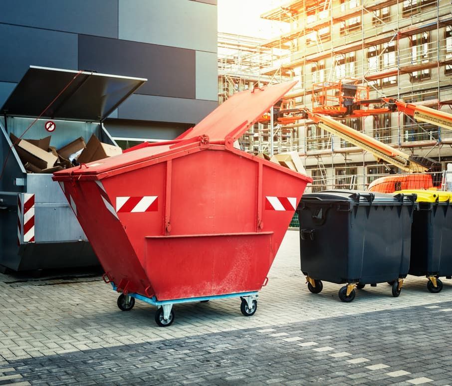 A Red Dumpster and Two Black Dumpsters — Totally Skip Bins in Canungra, QLD