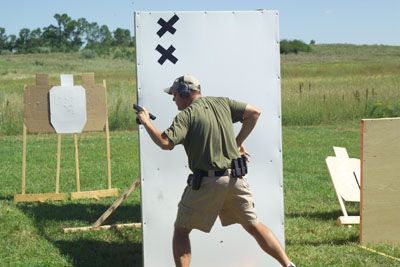 A man is standing in front of a white board with x 's on it.