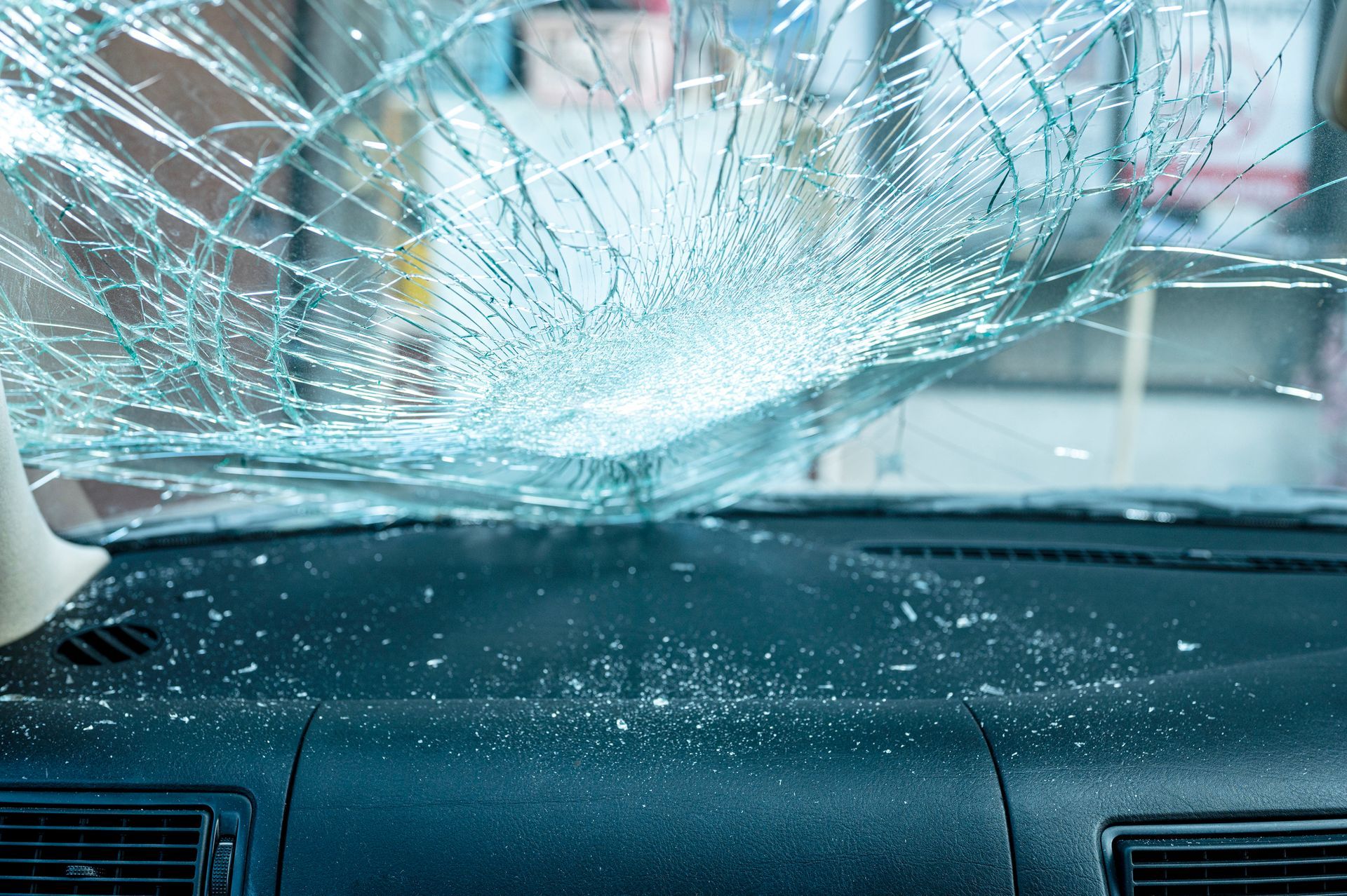 Car accident scene: Damaged car, flashing police lights, and three people looking distressed.