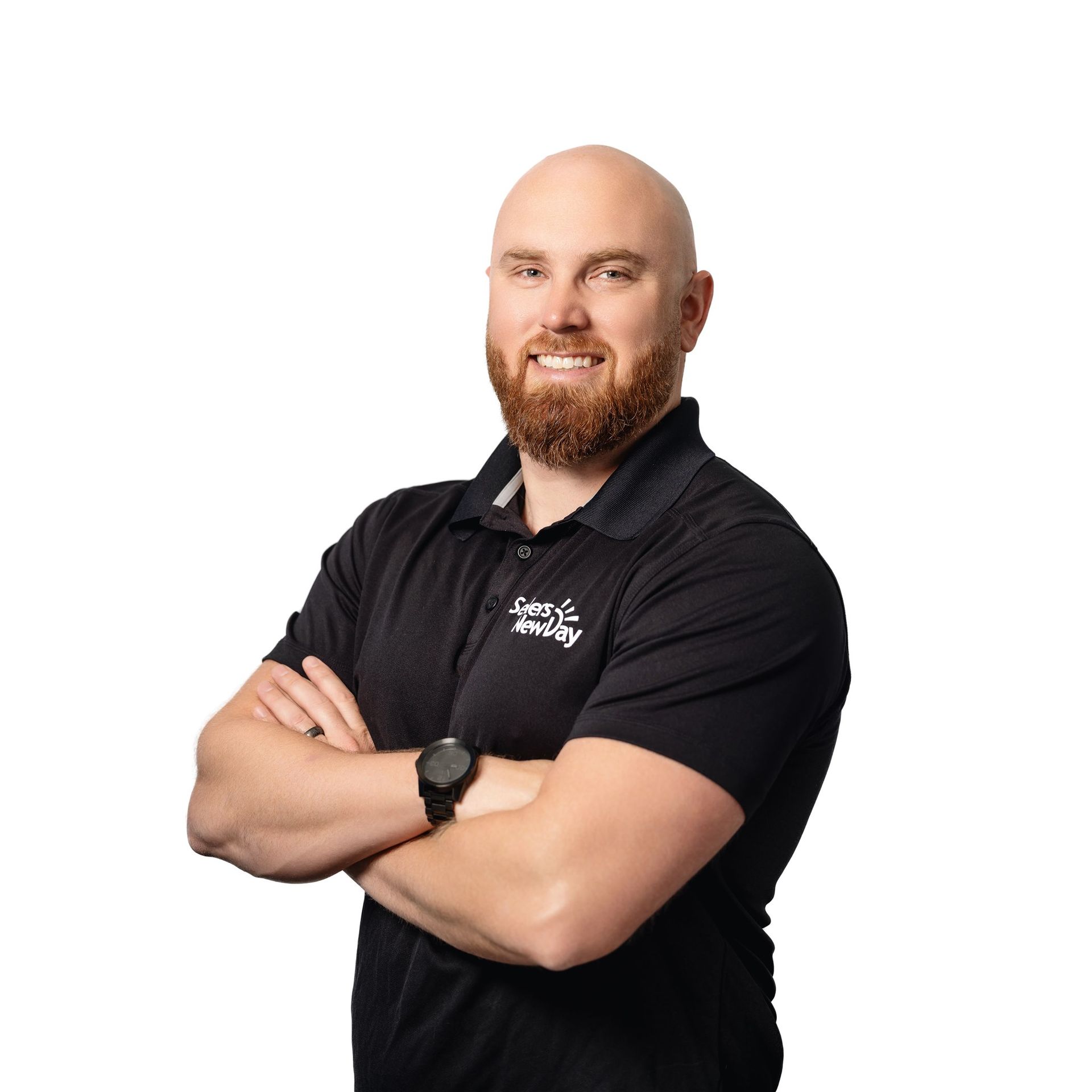 A bald man with a beard is wearing a black shirt and a watch.