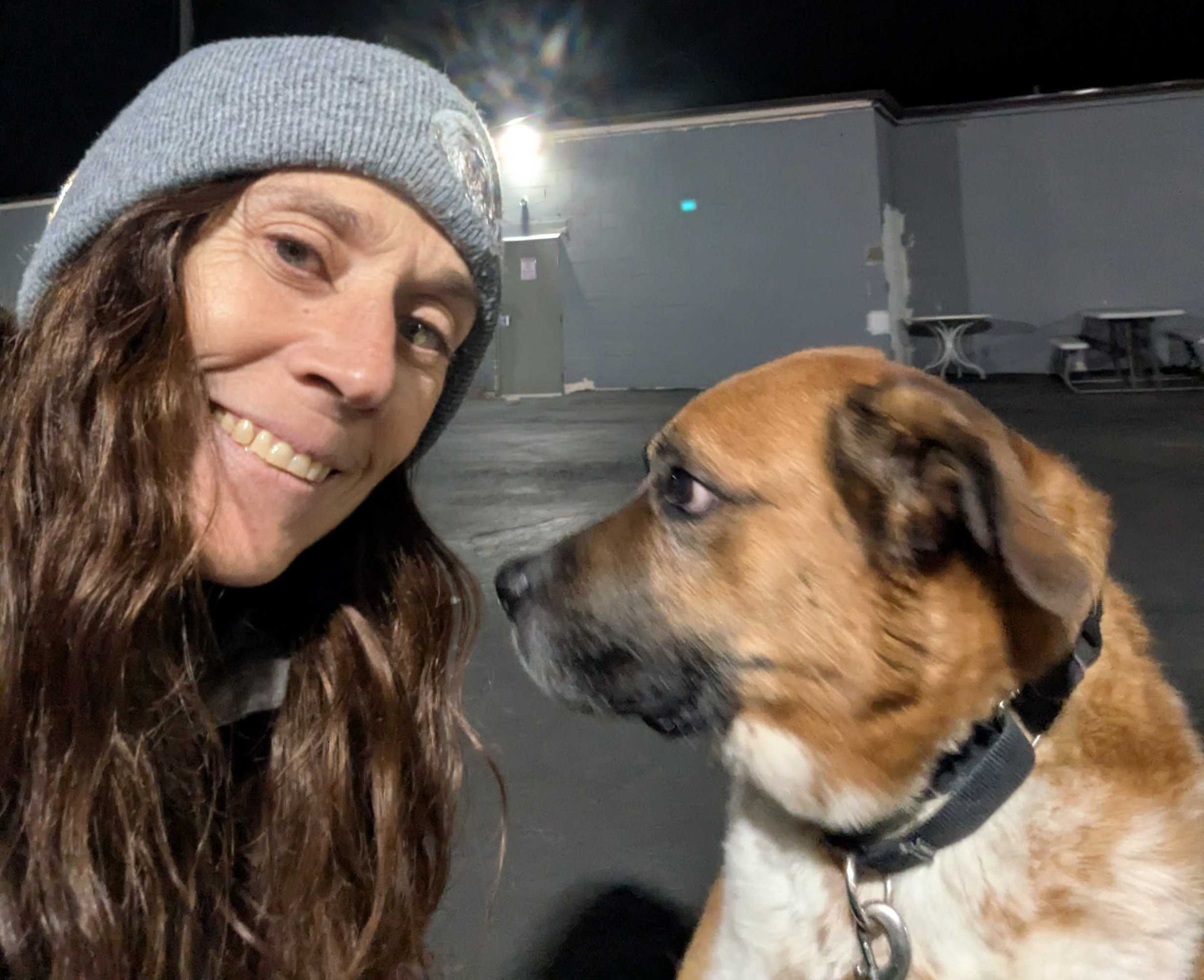 Smiling woman next to rescue dog