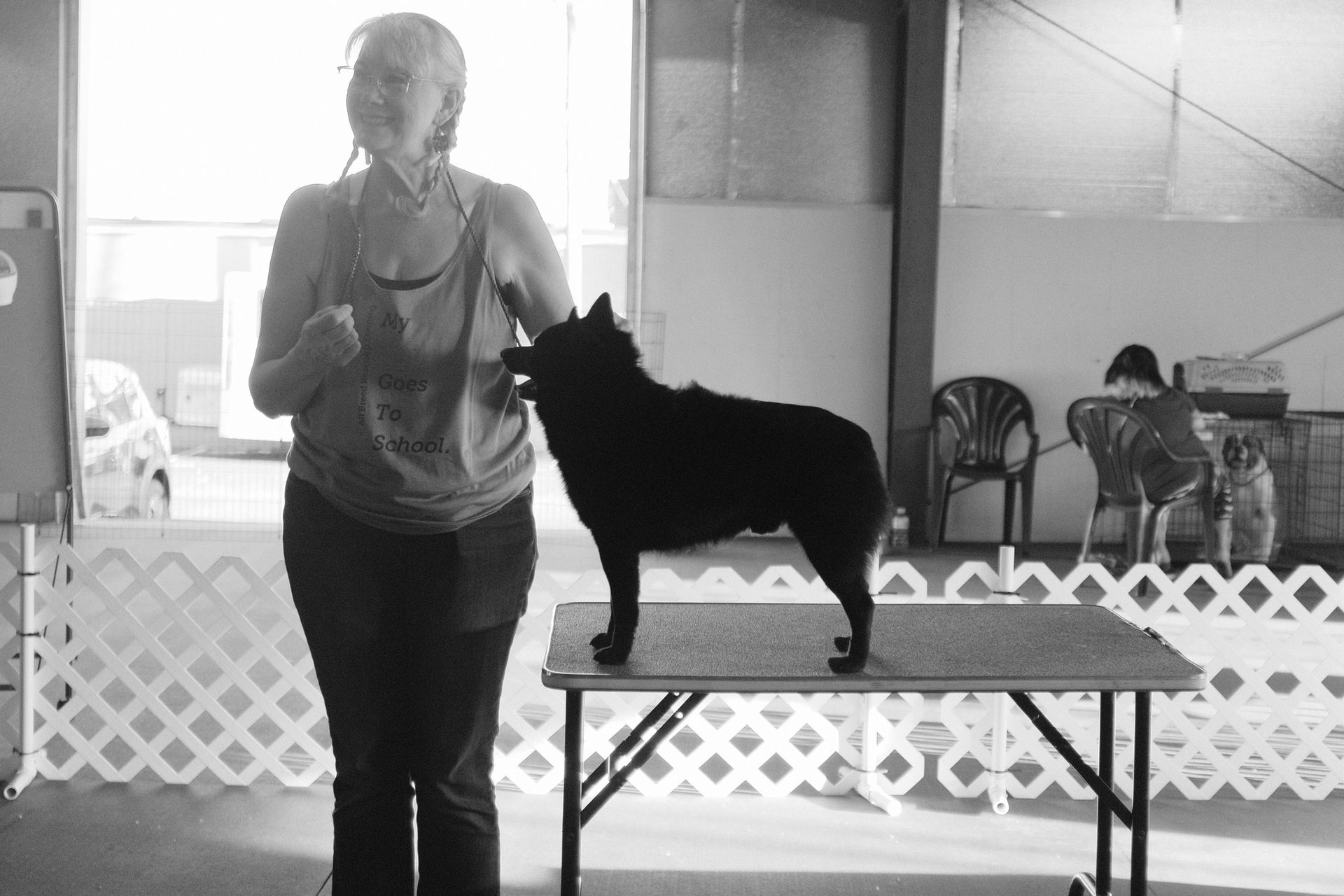 A schipperke and his mom await judging.