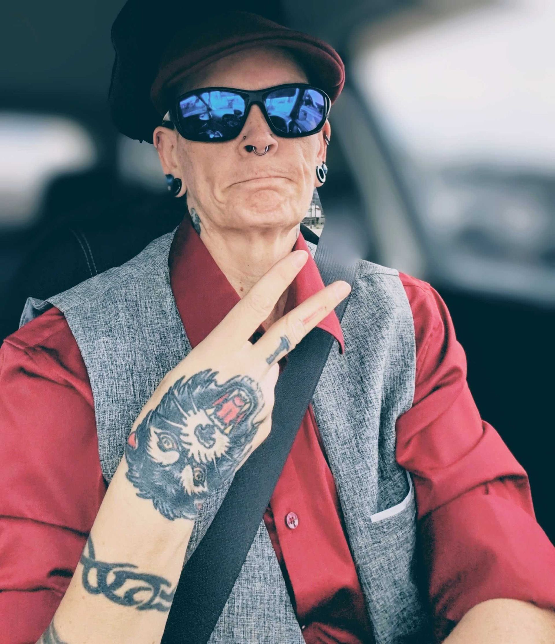 Rockstar tattooed bespecktacled friend in a dapper vest.