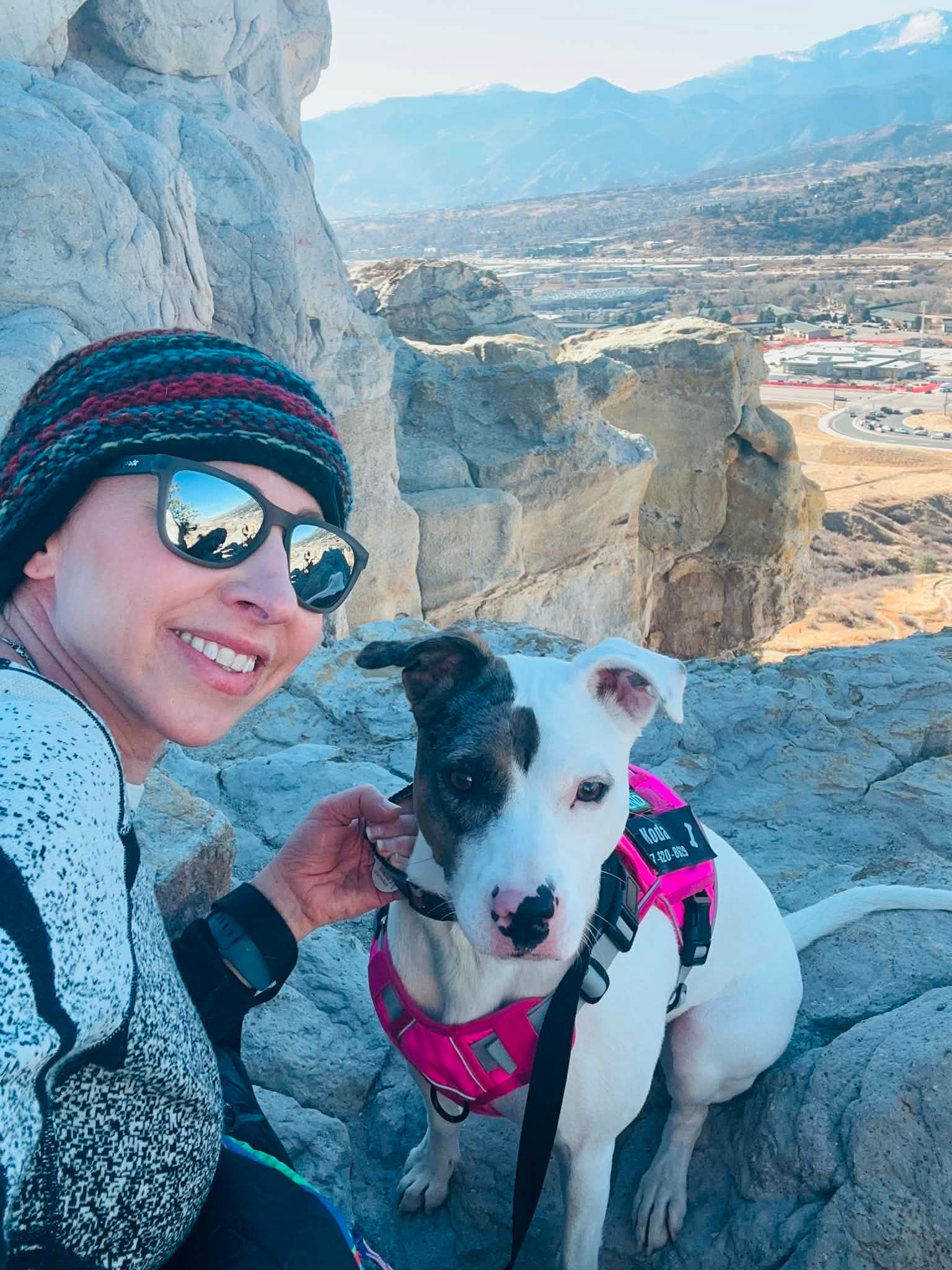 A young woman hiking with her rescue dog in Colorado