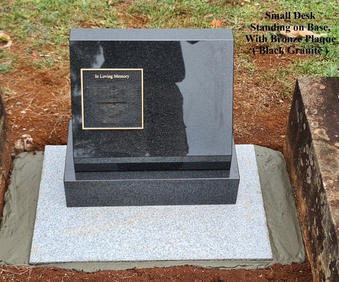 Black granite headstone with brass plaque, on grey base, in a cemetery — Mid Coast Monuments In Coffs Harbour, NSW