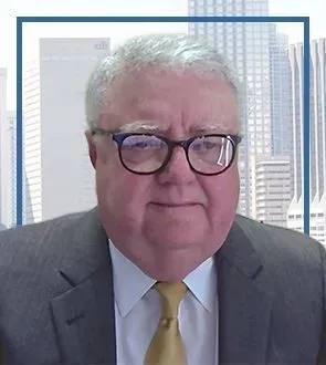 A man in a suit and tie is wearing glasses.