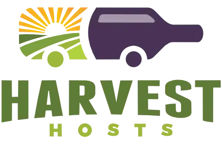 Harvest Hosts logo with green field, sun rays, and purple vehicle above the text