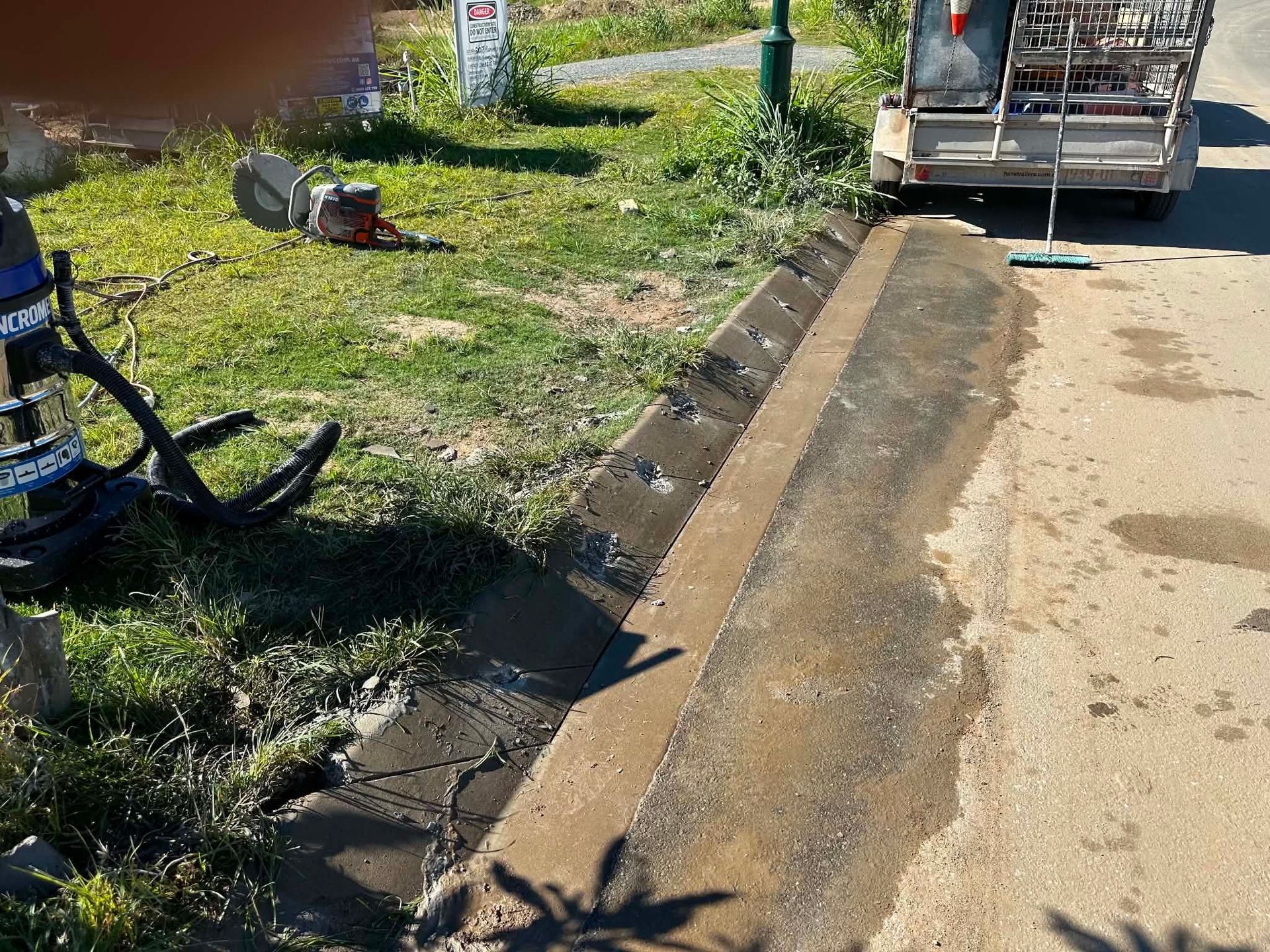 Roadside drainage ditch beside parked truck, with grass and a bicycle at left. — Ablecut Concrete Cutting & Coring In East Mackay, QLD