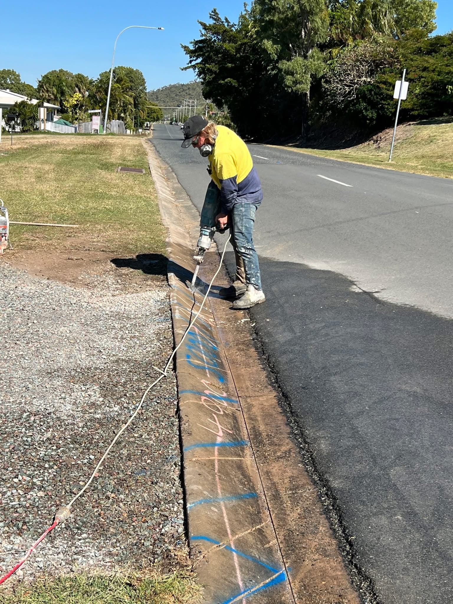 Worker Cutting Concrete Sidewalk With Power Saw Near — Ablecut Concrete Cutting & Coring In Sarina, QLD