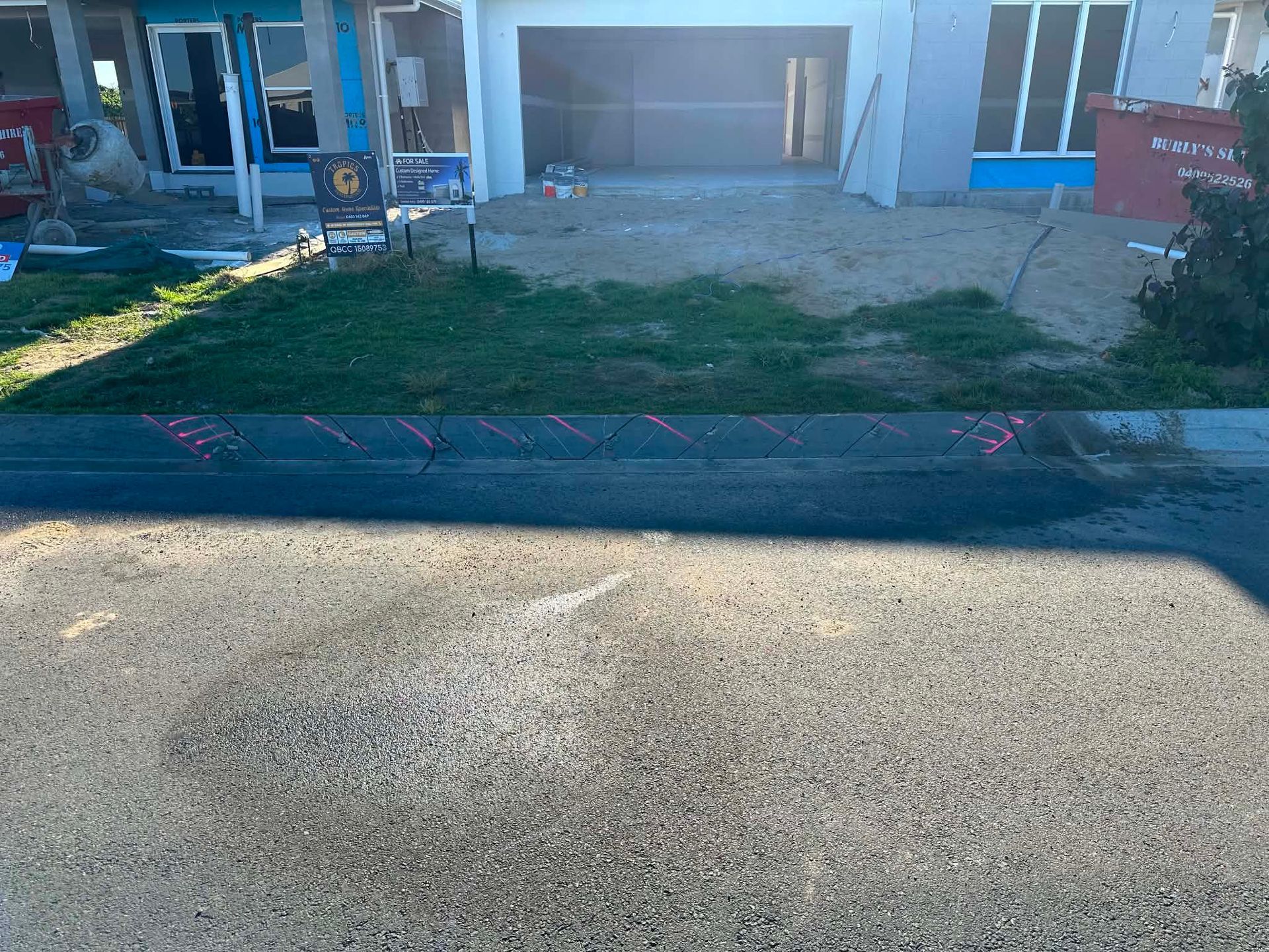 Front yard with a patchy grass lawn and driveway in front of a house entryway. — Ablecut Concrete Cutting & Coring In East Mackay, QLD