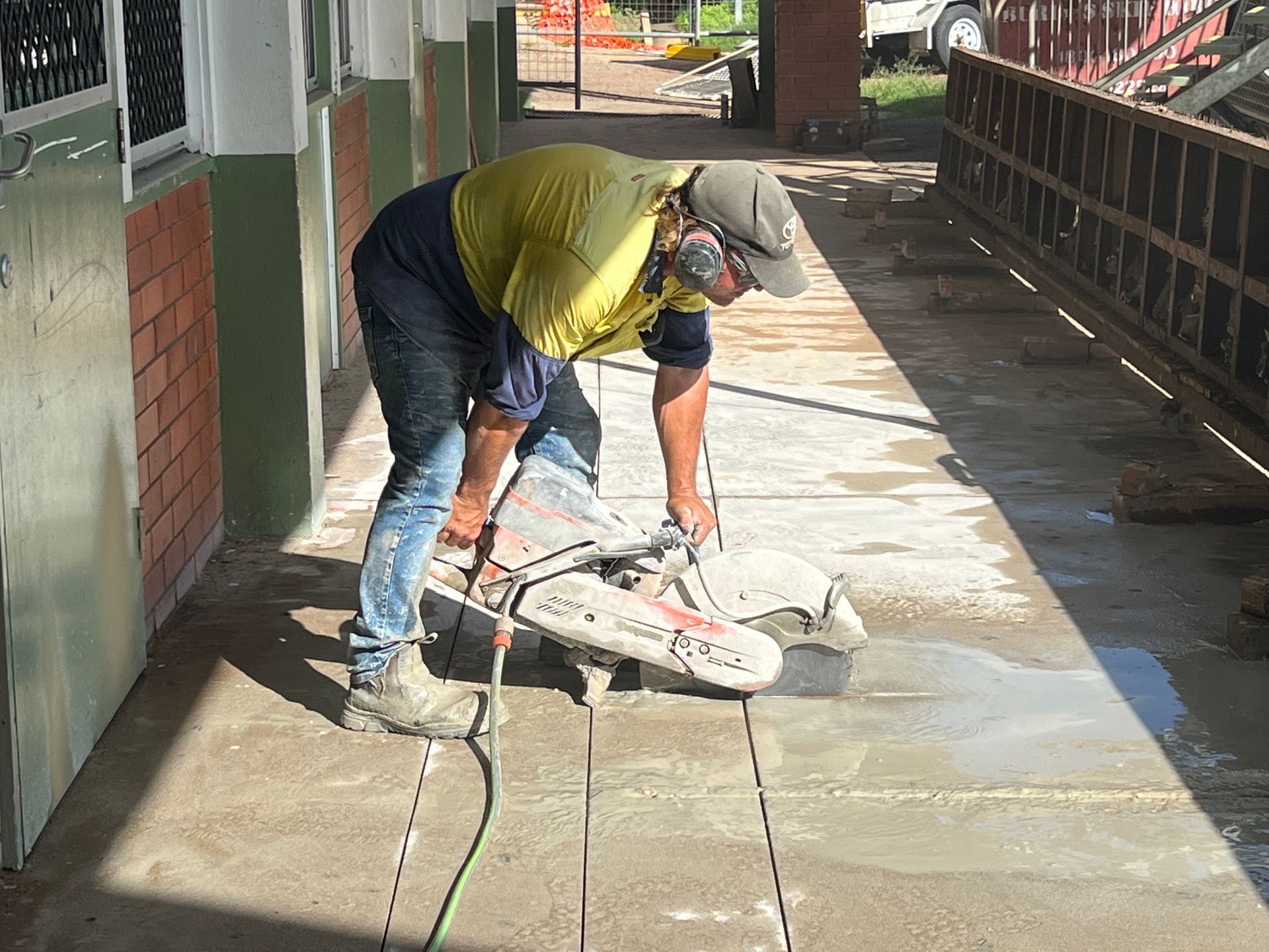 Concrete saw cutting a square section of concrete floor, with removed pieces beside the cut— Ablecut Concrete Cutting & Coring In Sarina, QLD