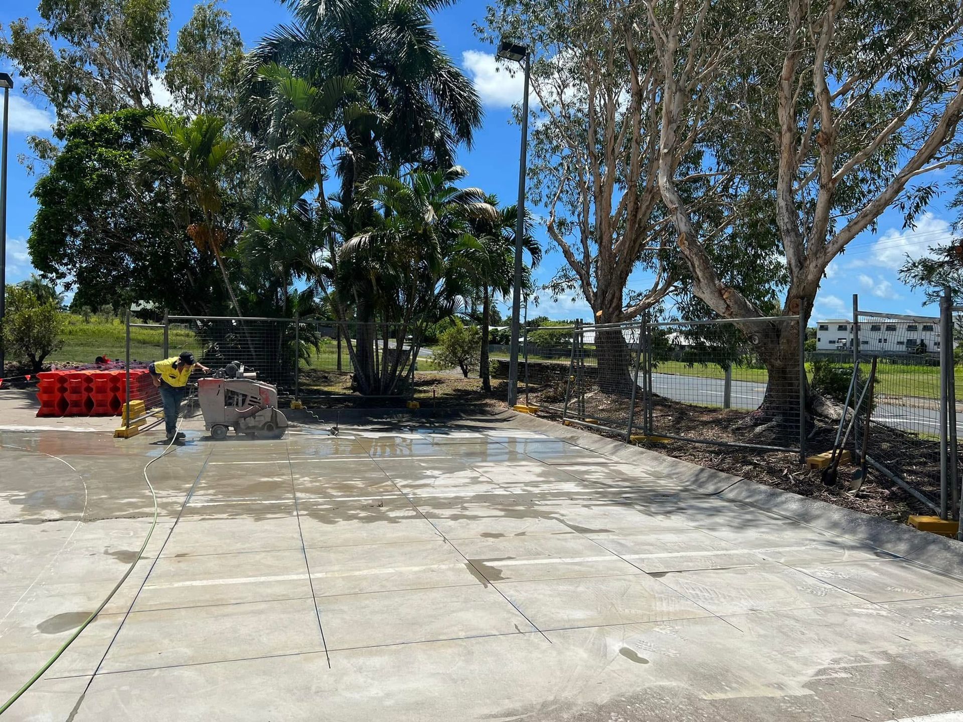 Worker Operating a Concrete Saw on a Wet Pavement — Ablecut Concrete Cutting & Coring In East Mackay, QLD