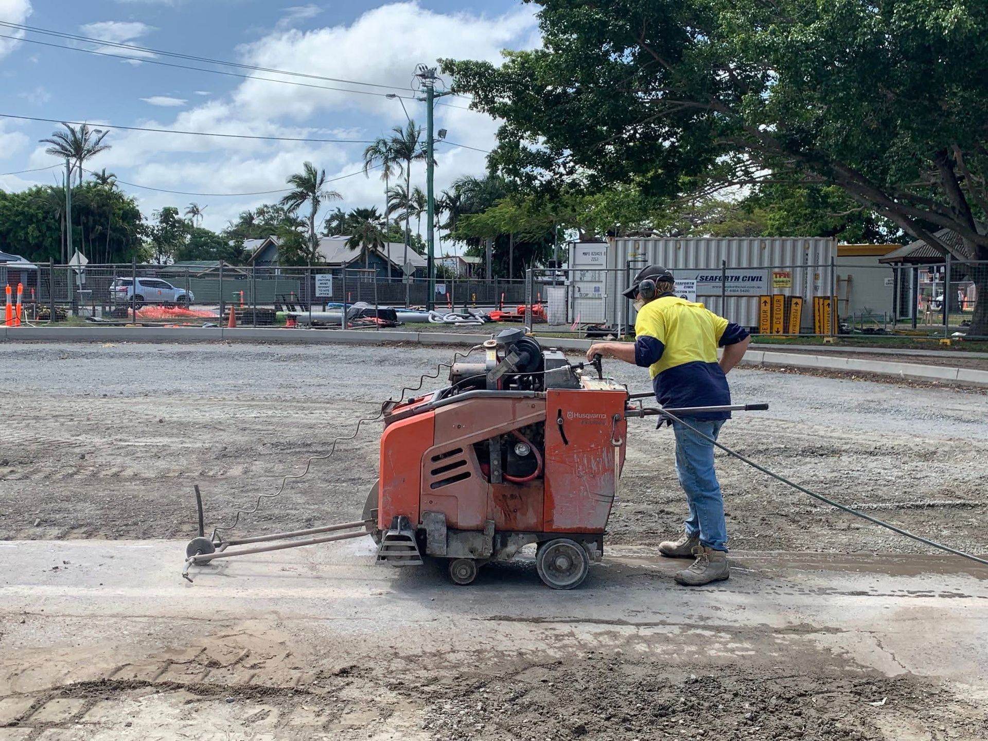 Construction Worker Using a Concrete Saw to Cut a Line in a Pavement — Ablecut Concrete Cutting & Coring In East Mackay, QLD