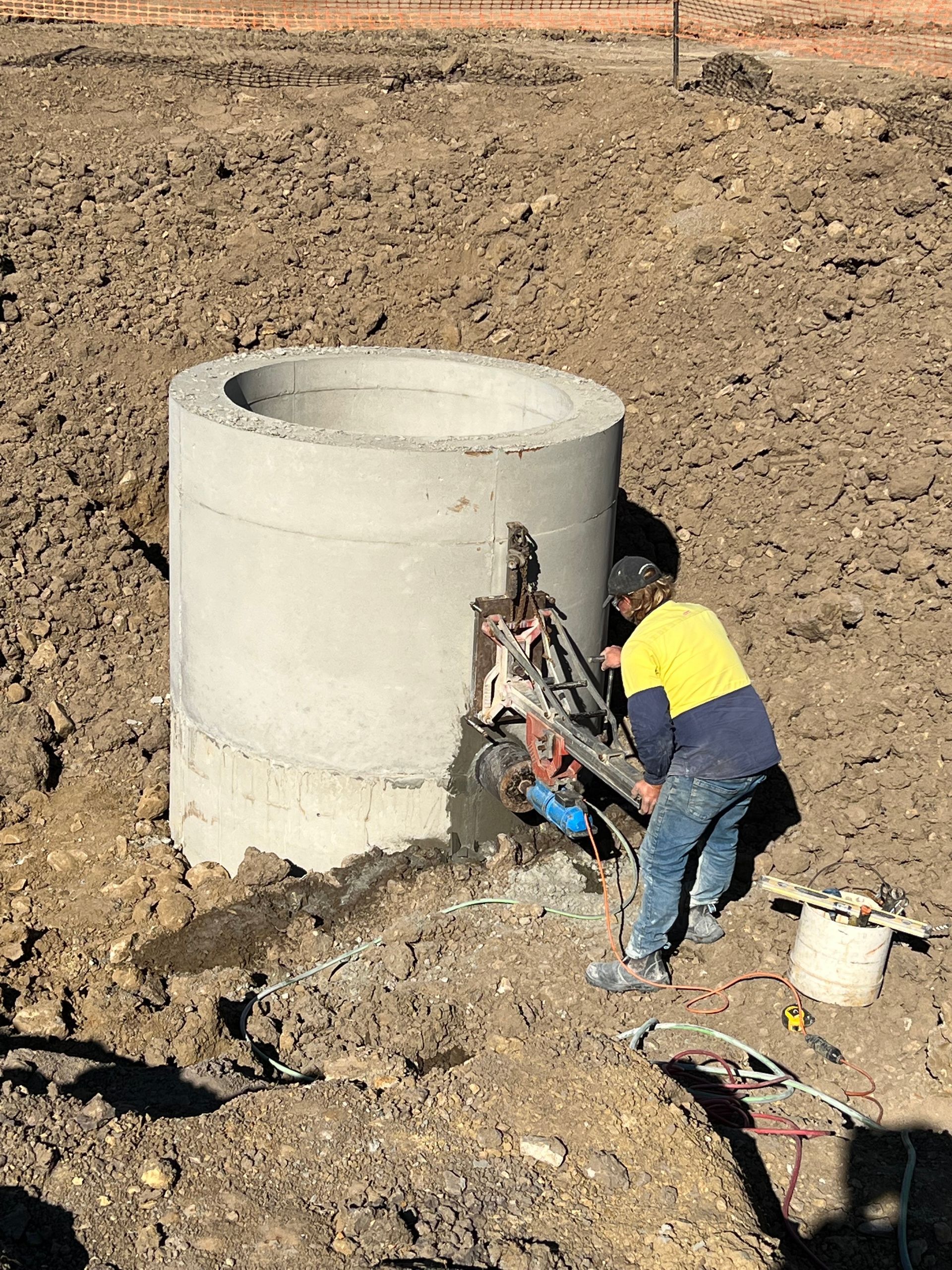 Worker Using a Vibratory Plate Compactor on a Pebble Surface — Ablecut Concrete Cutting & Coring In East Mackay, QLD