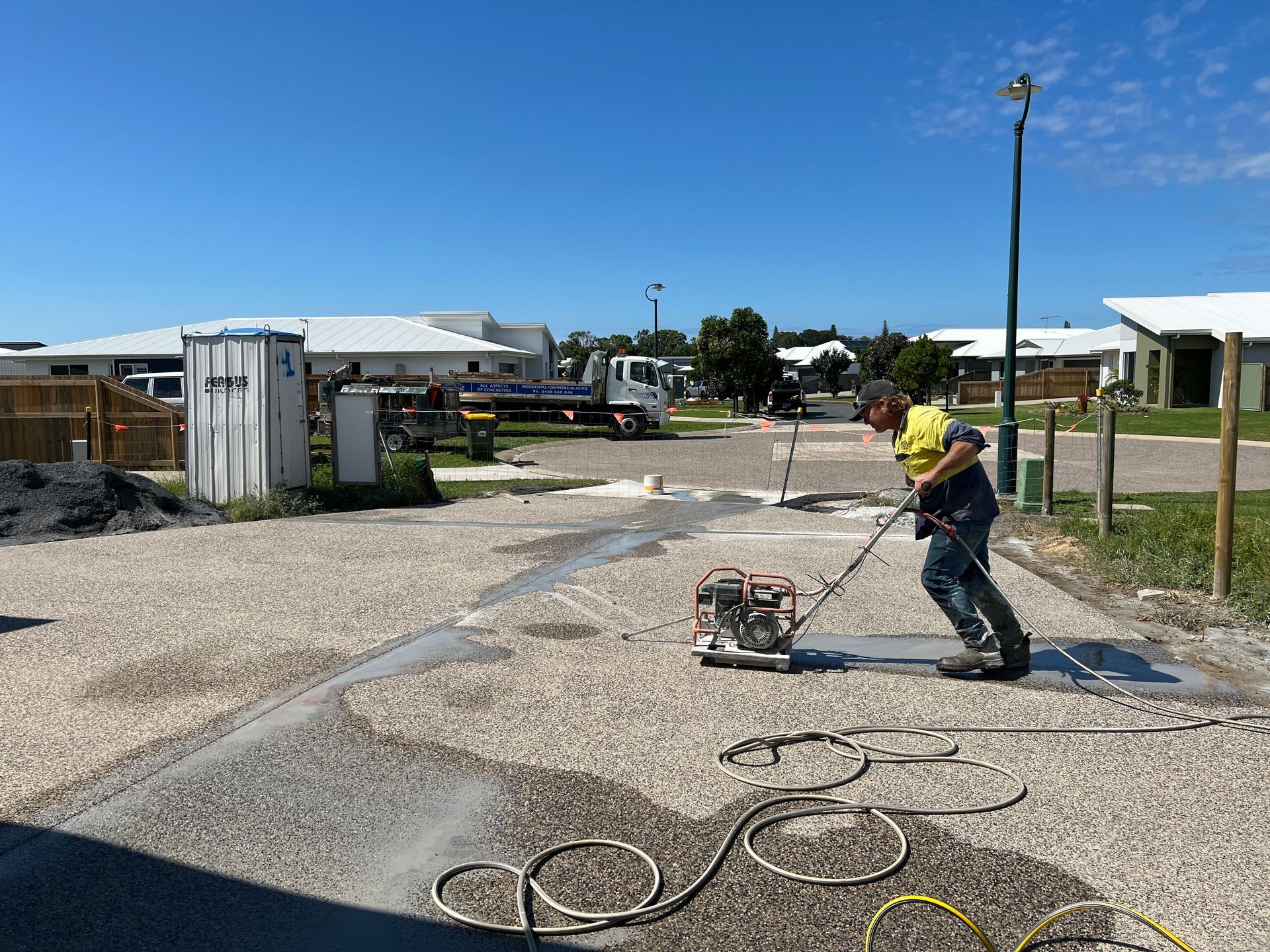 Worker Using a Vibratory Plate Compactor on a Pebble Surface — Ablecut Concrete Cutting & Coring In East Mackay, QLD
