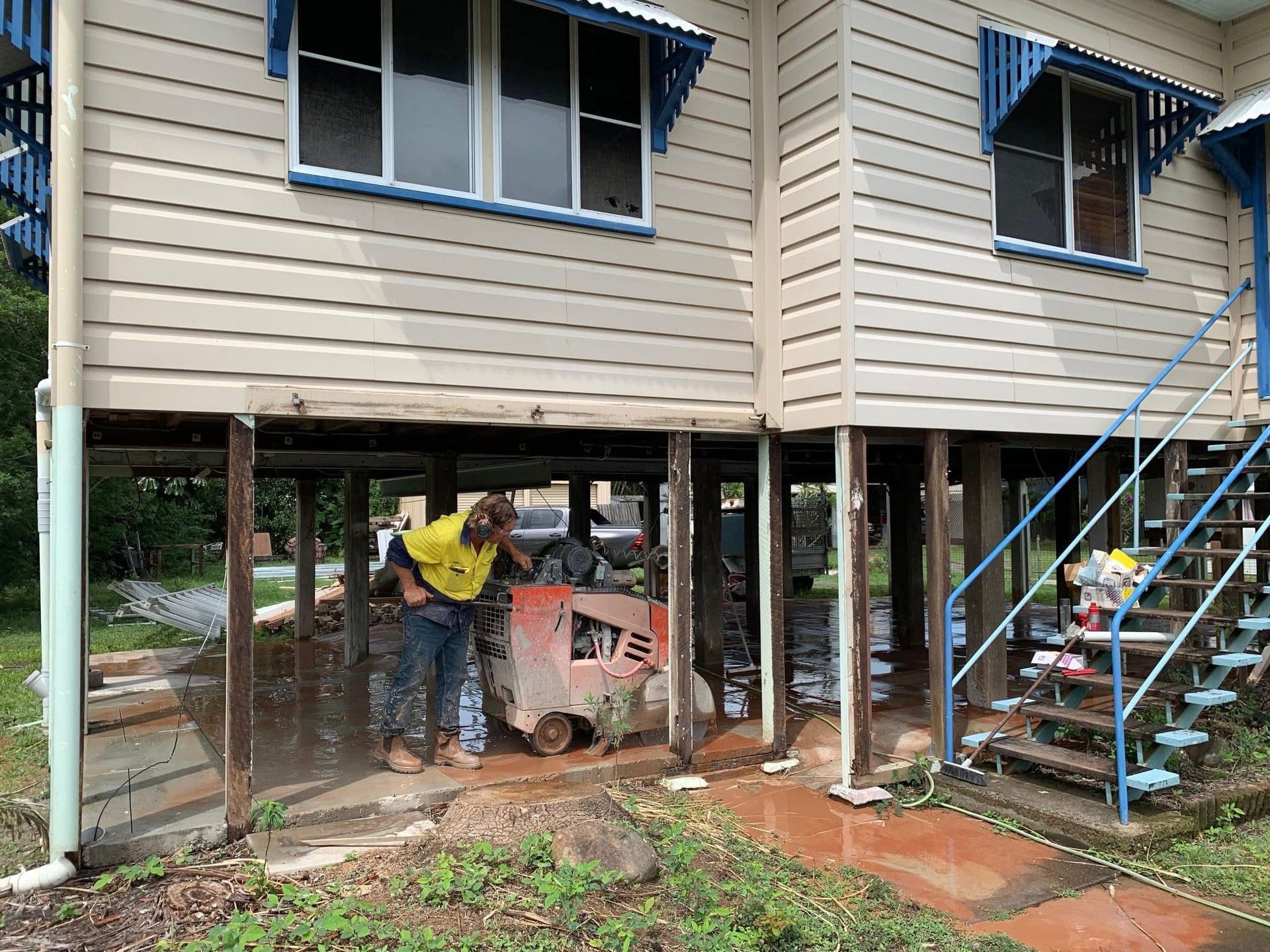 Worker Using a Handheld Cutoff Saw to Cut Pavement — Ablecut Concrete Cutting & Coring In East Mackay, QLD