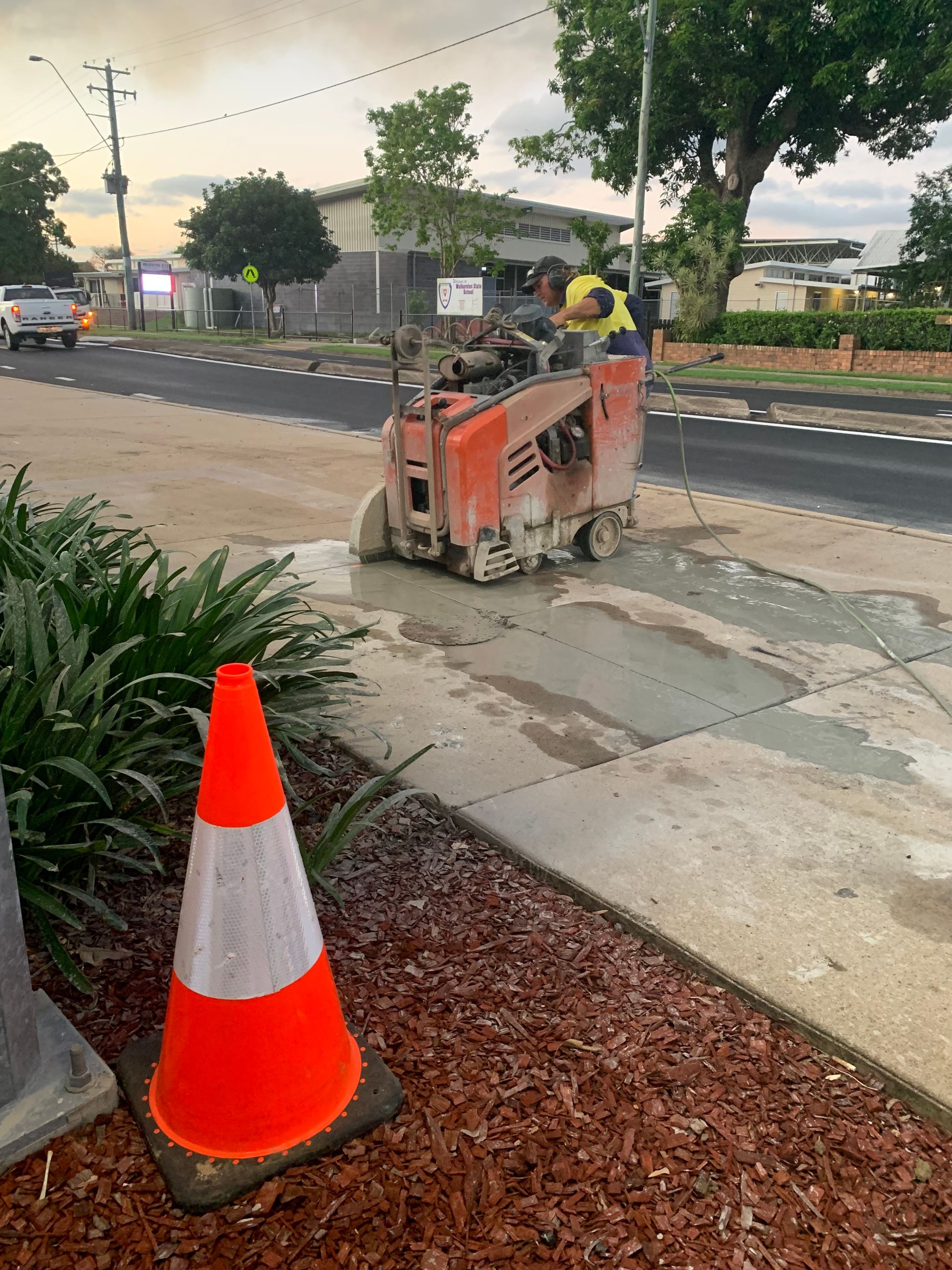 Construction Worker Using a Concrete Saw on a Sidewalk — Ablecut Concrete Cutting & Coring In East Mackay, QLD