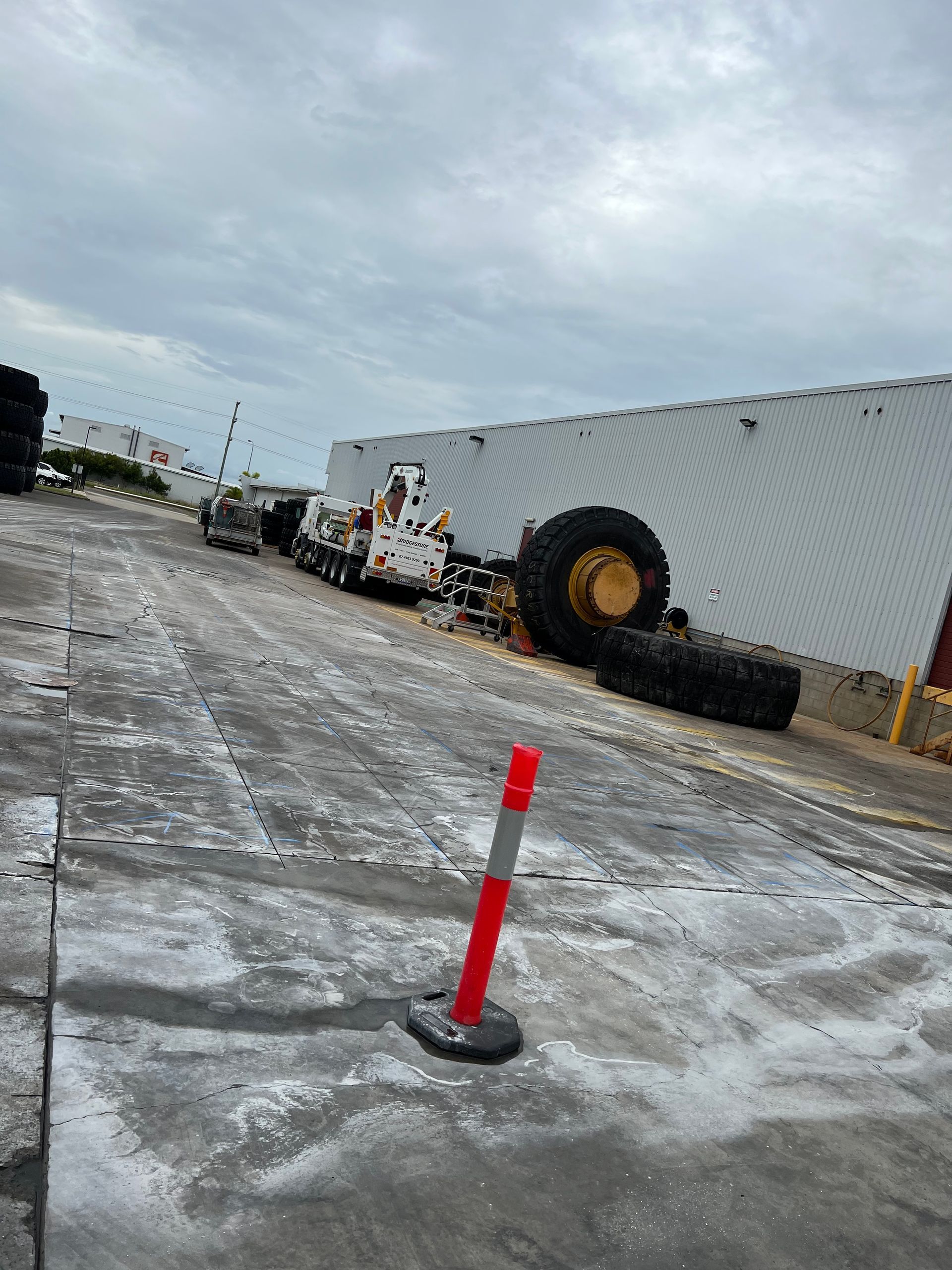 Large White and Yellow Construction Vehicle, Tipped Over — Ablecut Concrete Cutting & Coring In East Mackay, QLD
