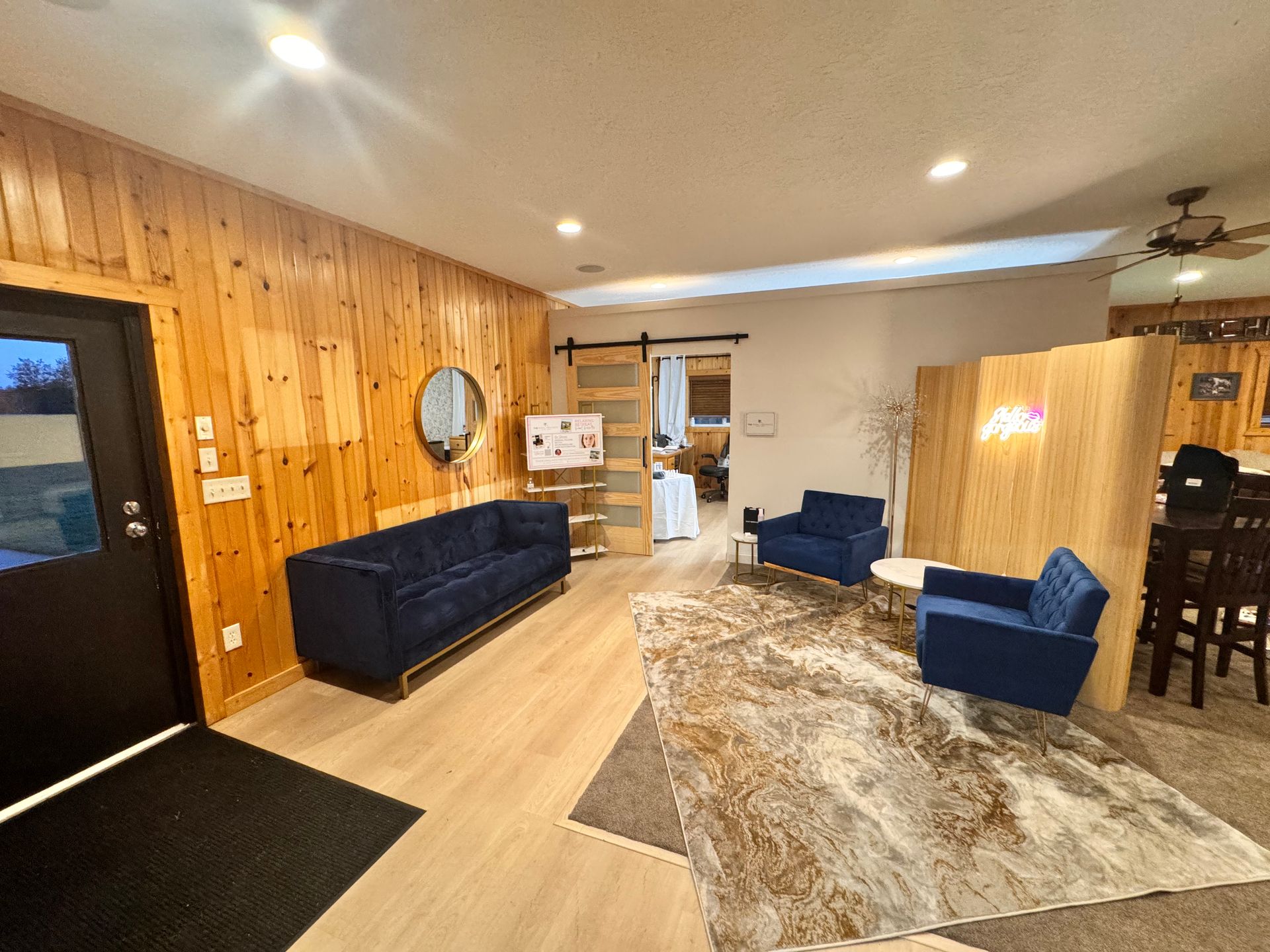 A living room with a couch , chairs , and a rug.