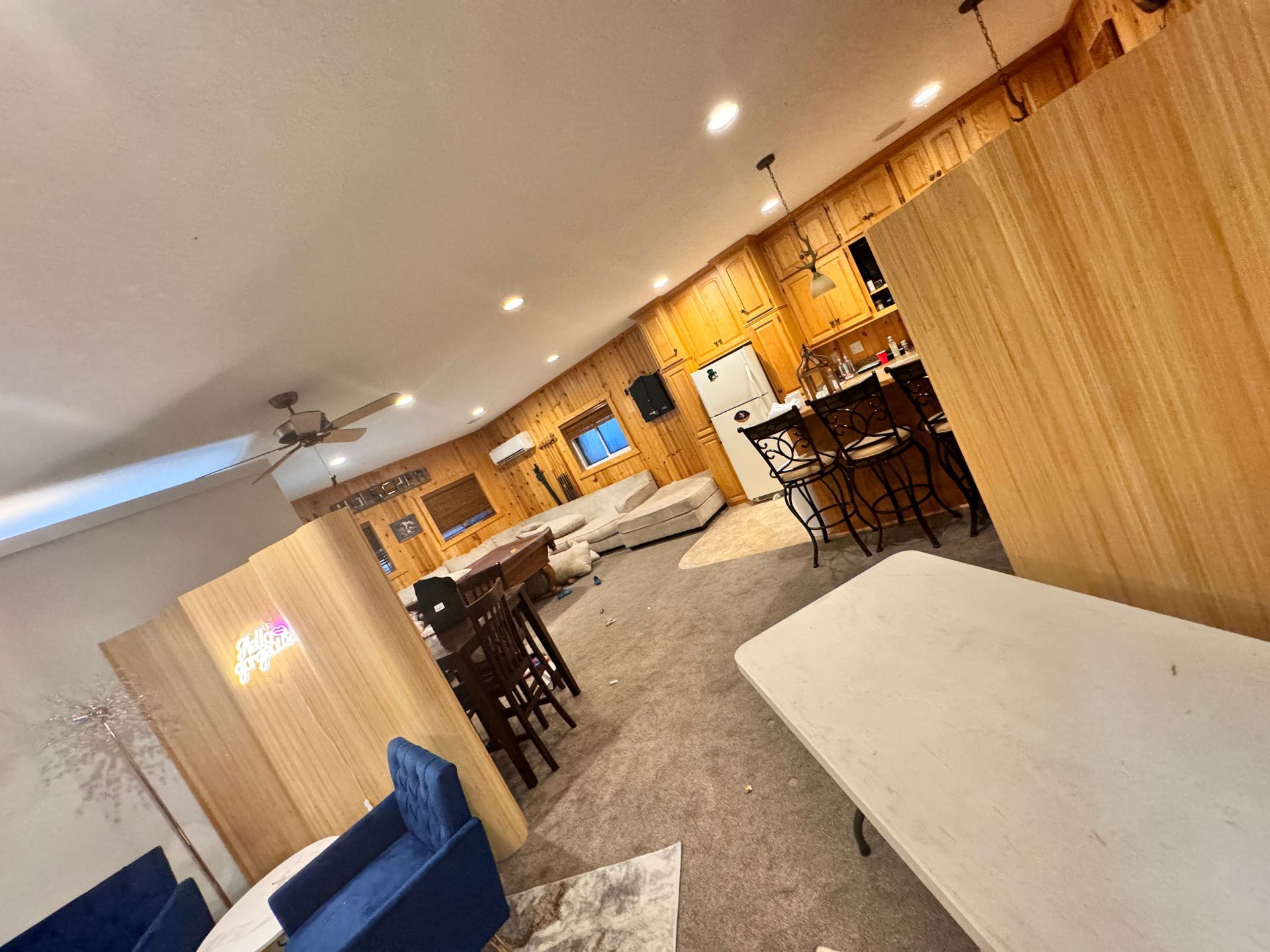 A living room with a table , chairs , and a couch.