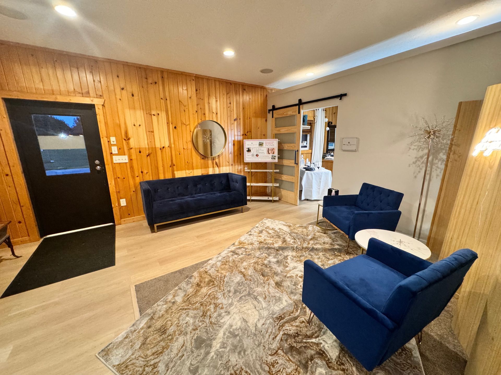 There is a couch and two chairs in the living room.