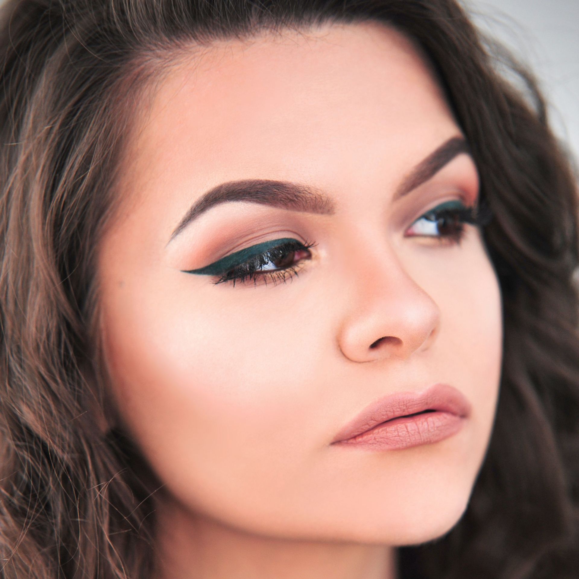 A close up of a woman 's face with makeup on.