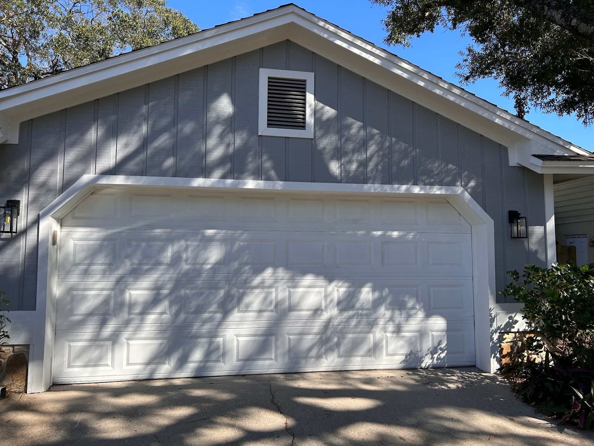 A gray house with a white garage door