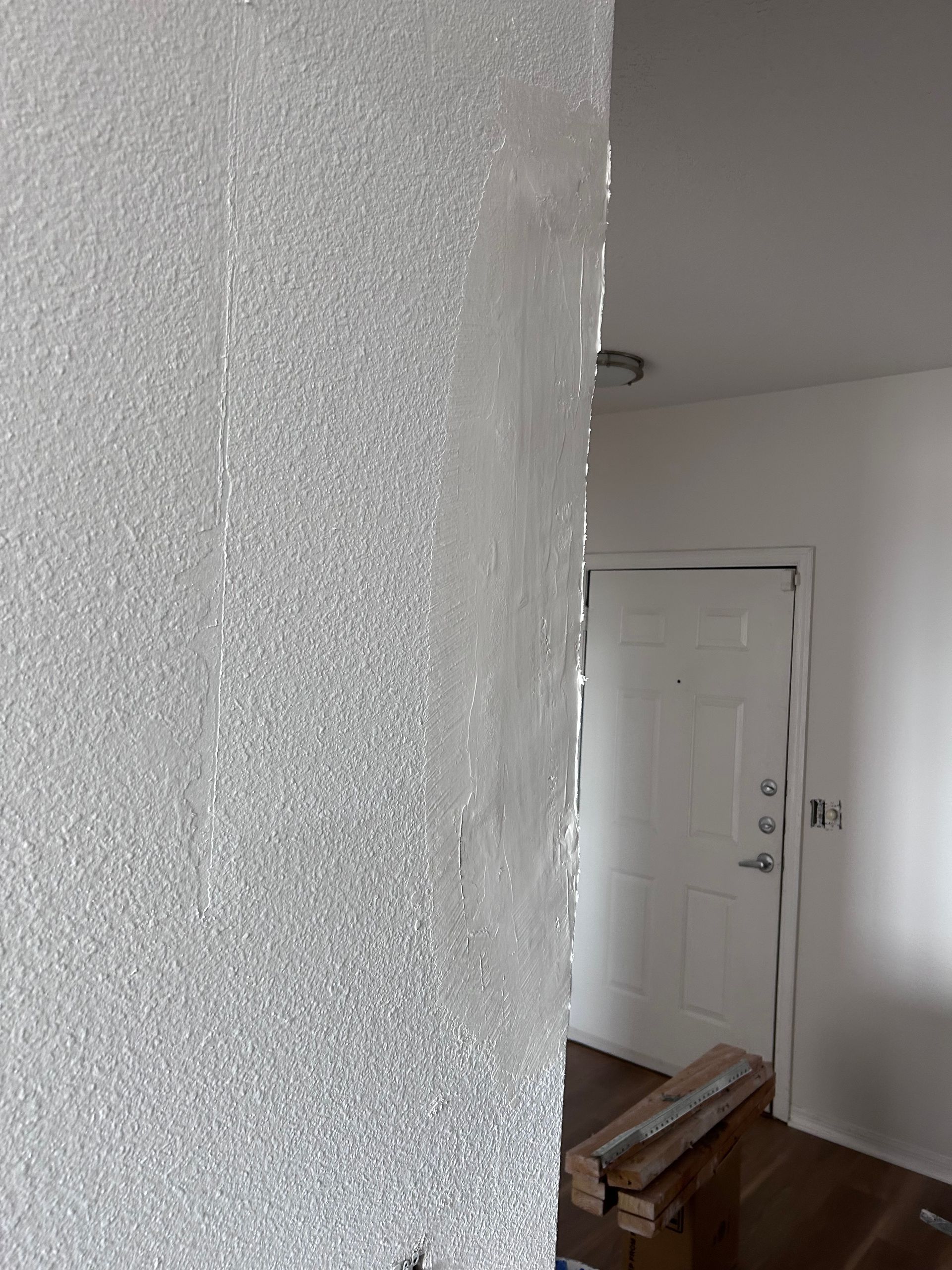 Textured, sparkly wall partially obscures a doorway and interior.