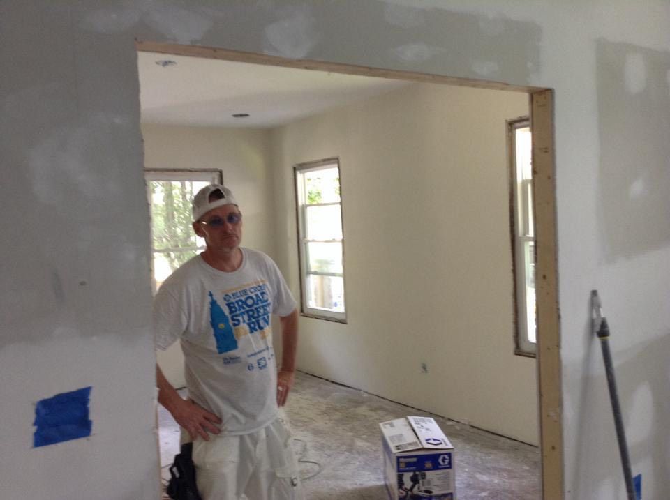 A man is standing in a room with a box on the floor.