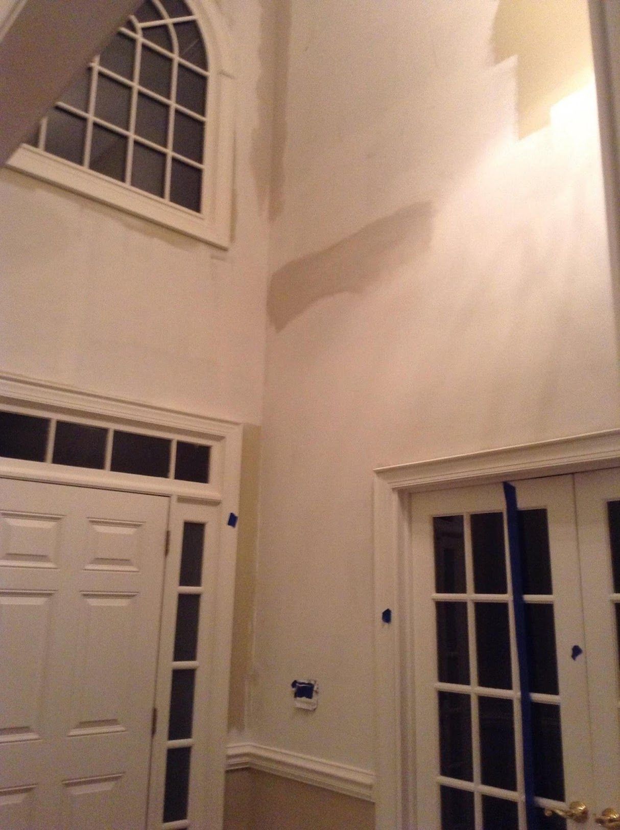 A room with two doors and a window on the wall