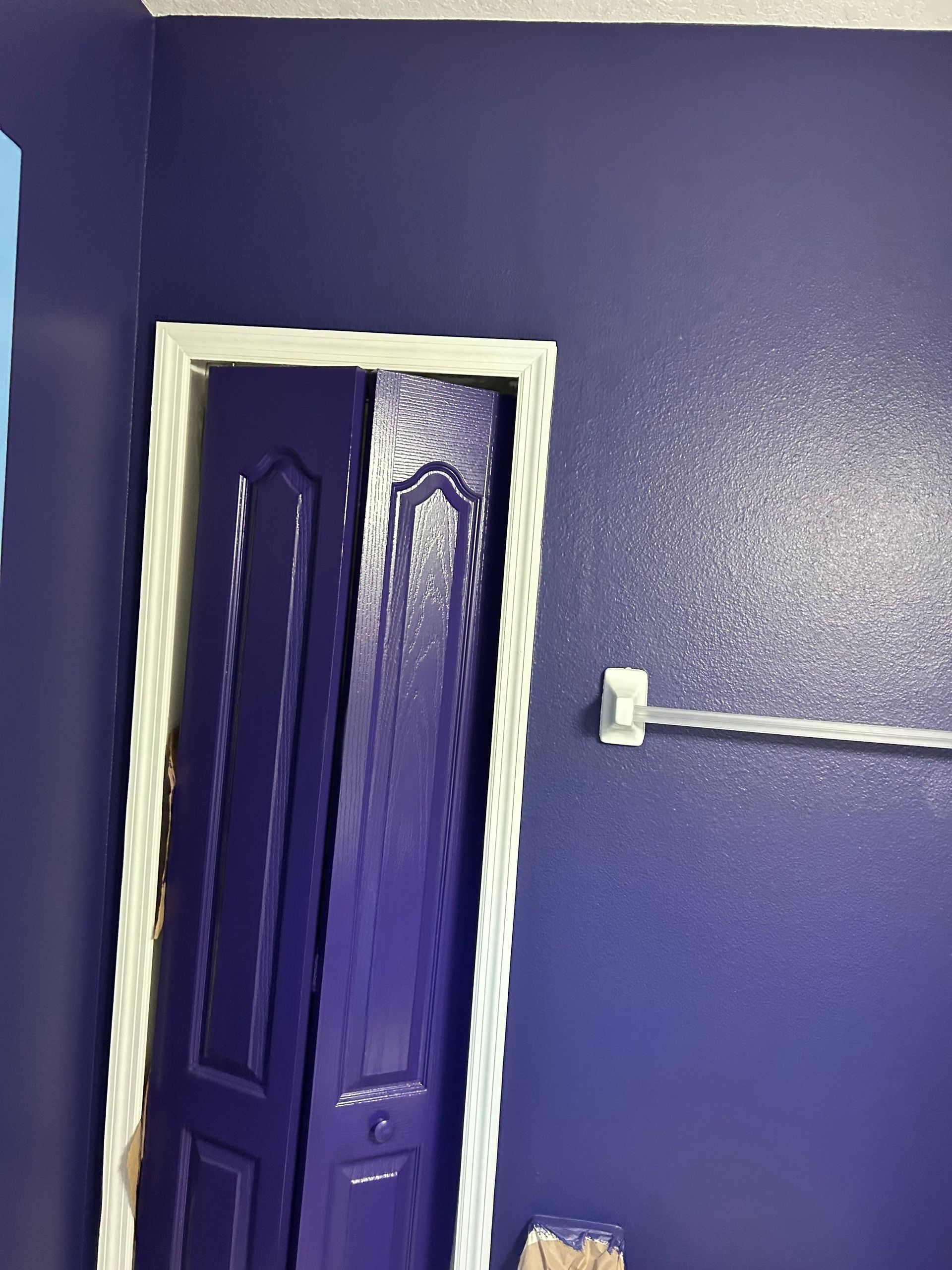 A bathroom with purple walls and a purple door