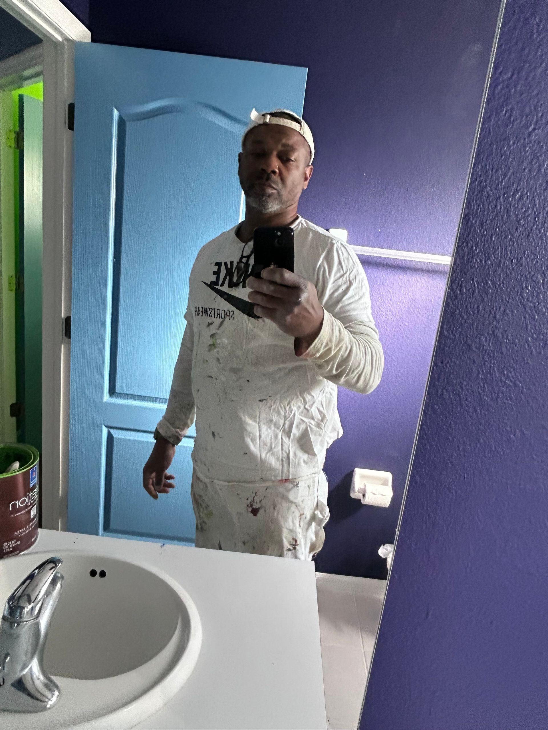 A man taking a picture of himself in a bathroom mirror