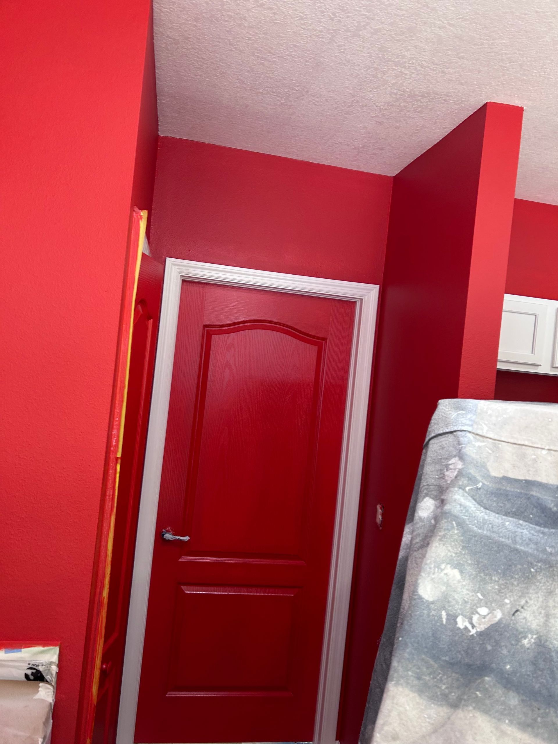 A red door in a room with red walls