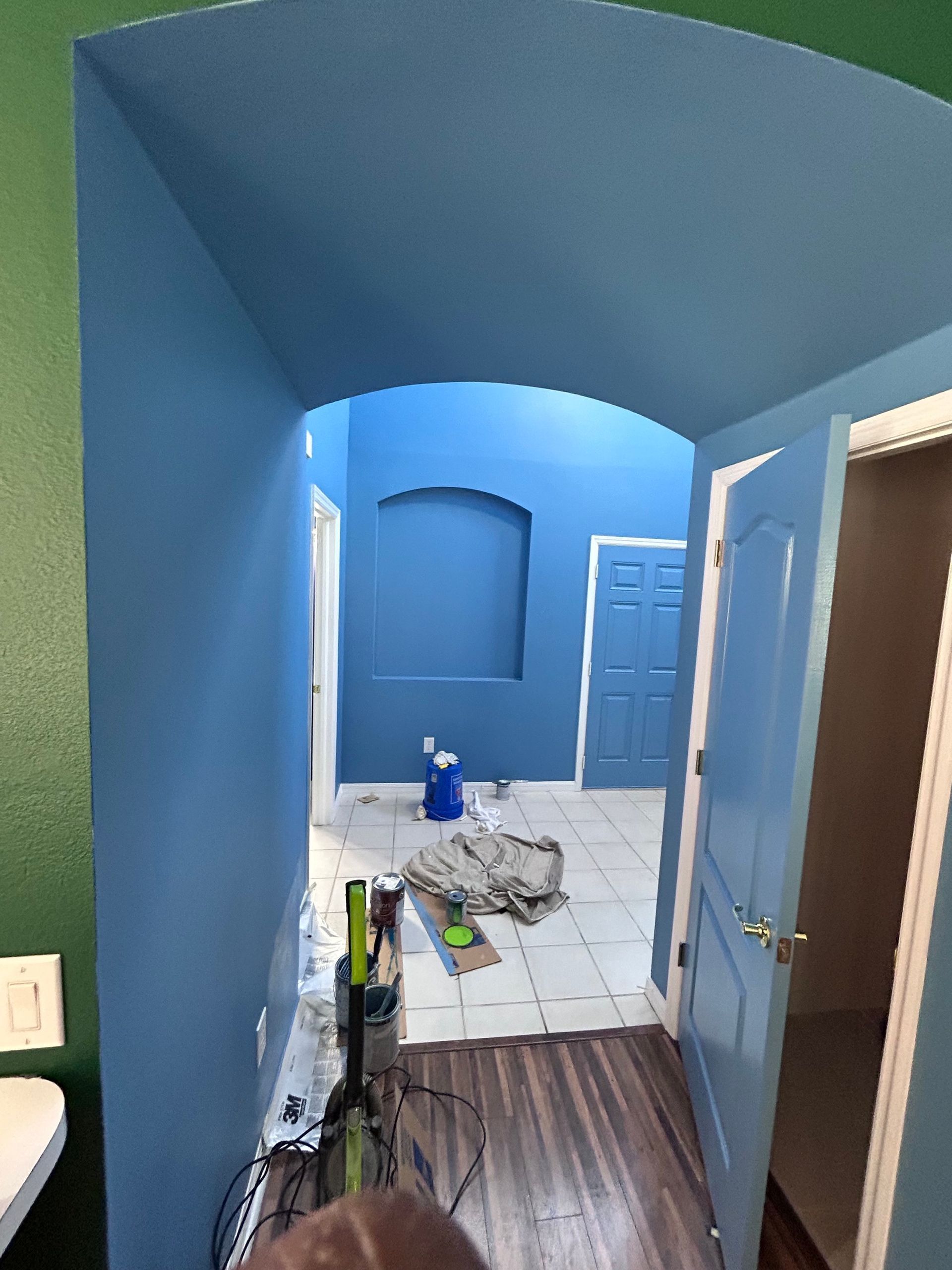 A hallway with blue walls and green walls