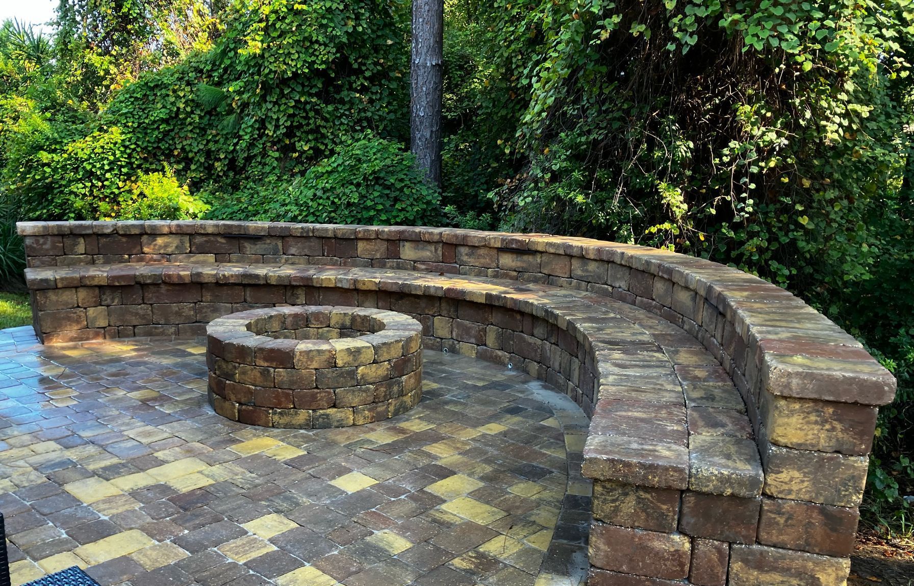 There is a fire pit in the middle of the patio.