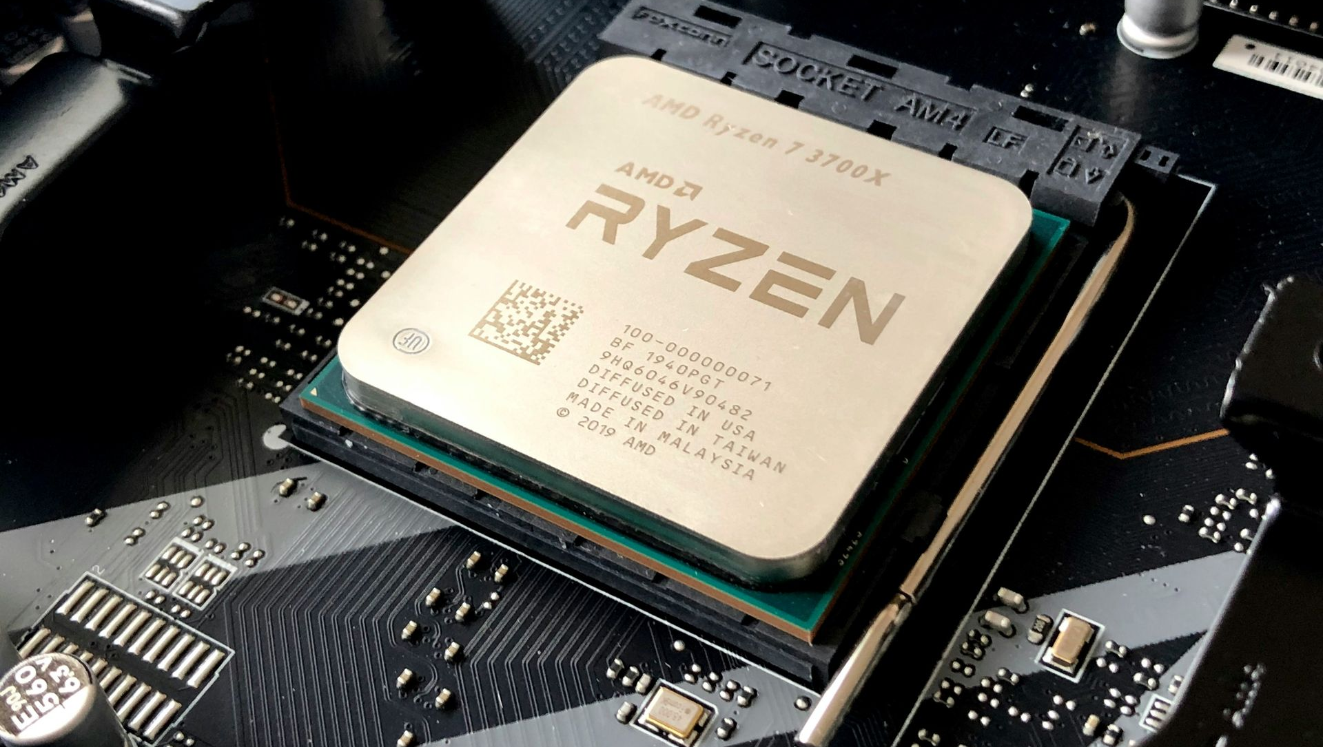 AMD Ryzen CPU installed on a black circuit board, with the Ryzen logo visible.