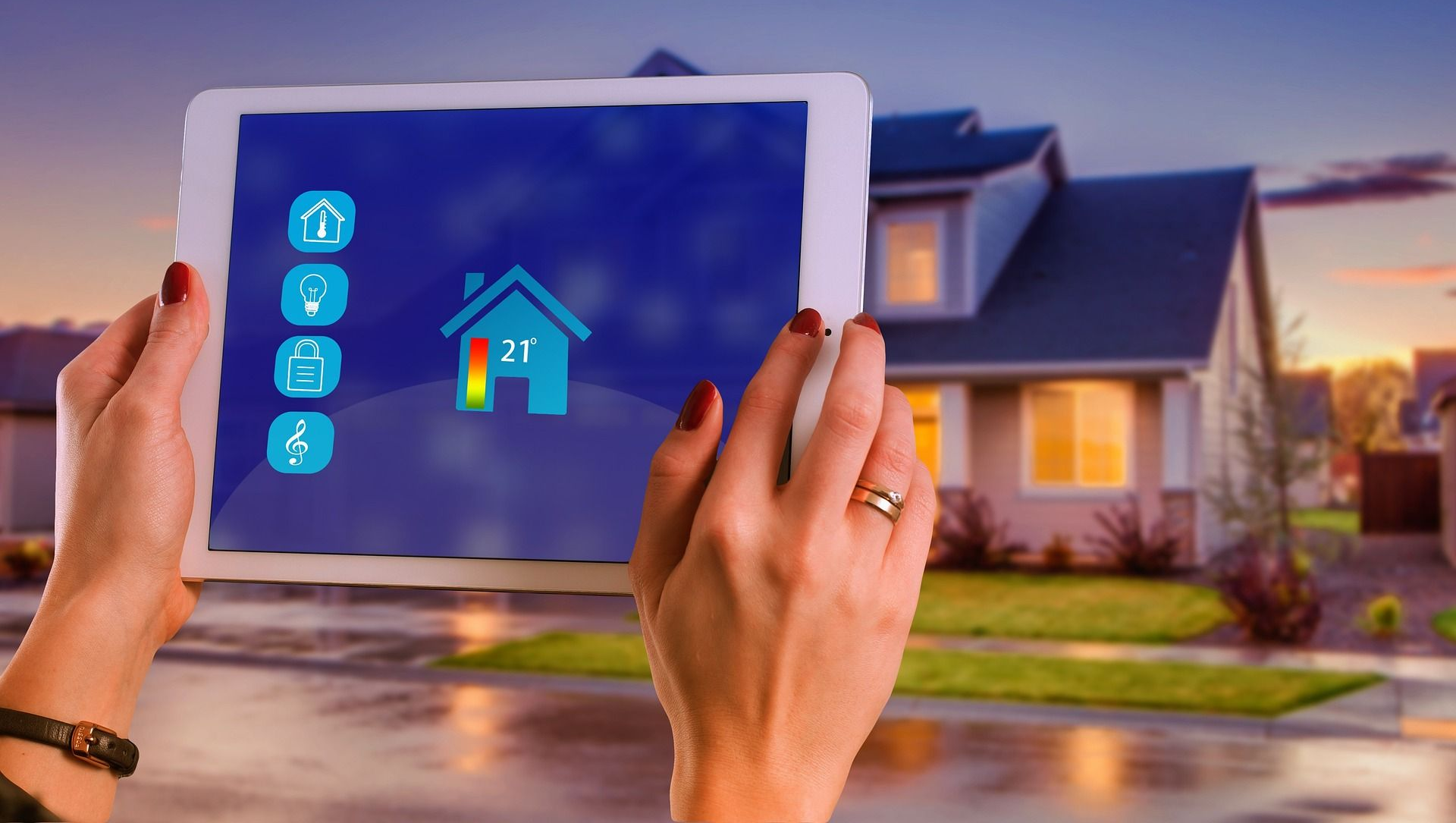 Woman holding a tablet with smart home app in front of a house.