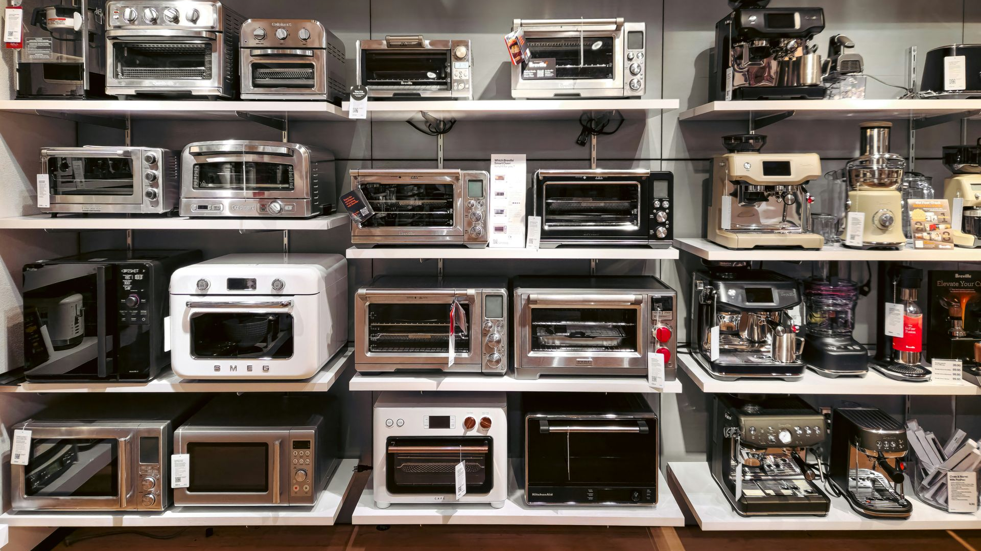 Shelves display a variety of small kitchen appliances: toasters, ovens, and coffee makers.