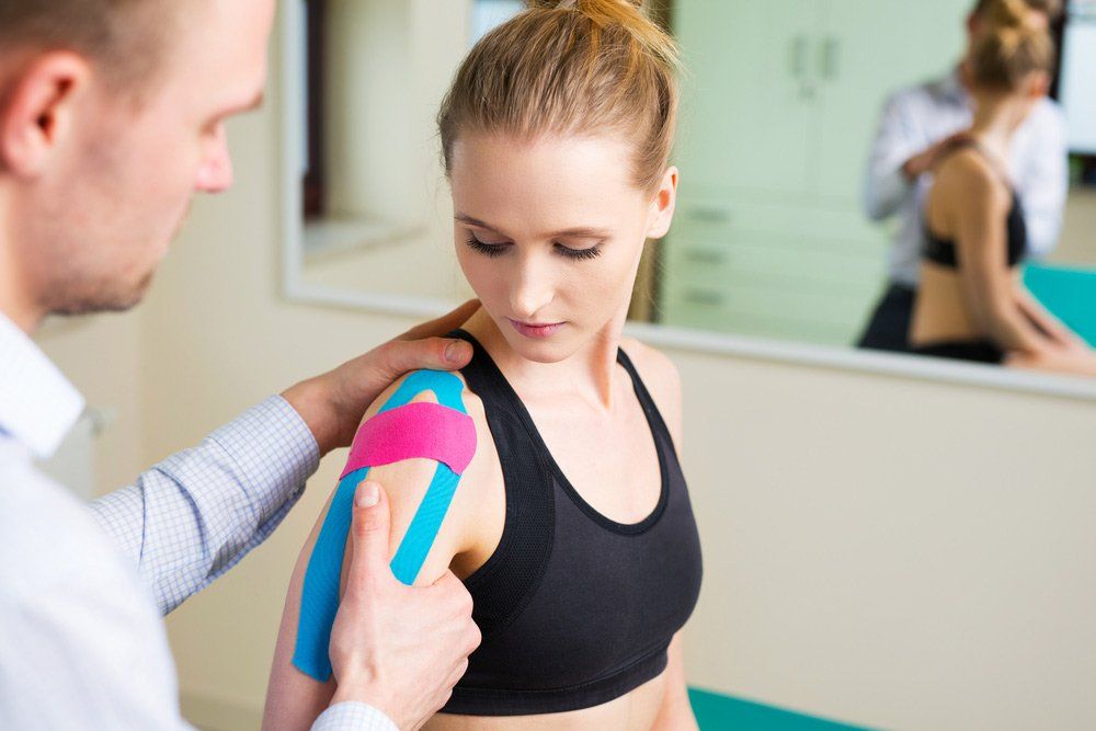 Woman Having Shoulder Physical Therapy With Kinesiotaping — PhysioCare Townsville In Thuringowa Central, QLD