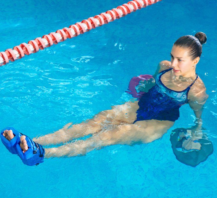 Woman Doing Water Hydrotherapy in Indoor Pool — PhysioCare Townsville In Thuringowa Central, QLD