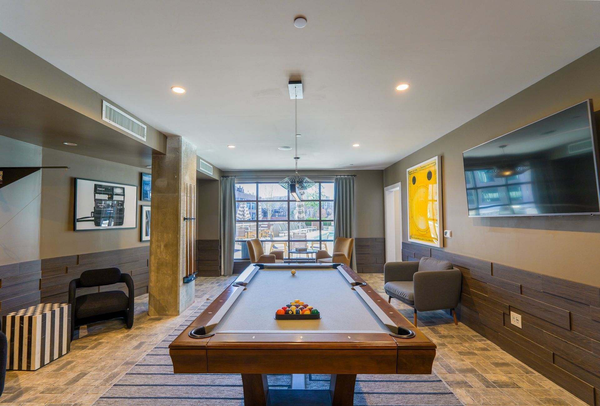 There is a pool table in the middle of the room.