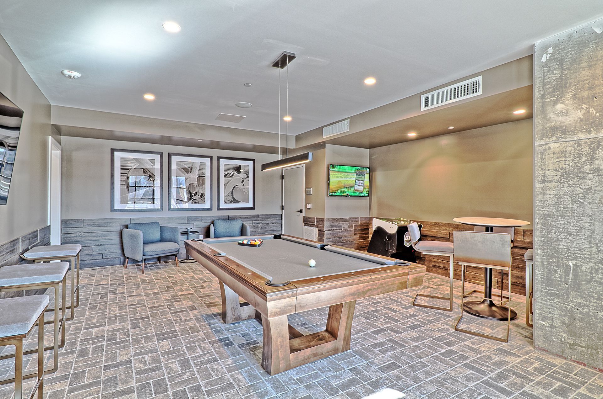 There is a pool table in the middle of the room.