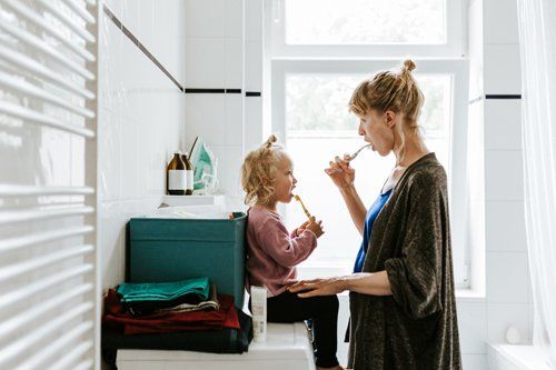 Mother with A Child Brushing Teeth — Eastpointe, MI — Universal Dental Center Mother with A Child Brushing Teeth — Eastpointe, MI — Universal Dental Center